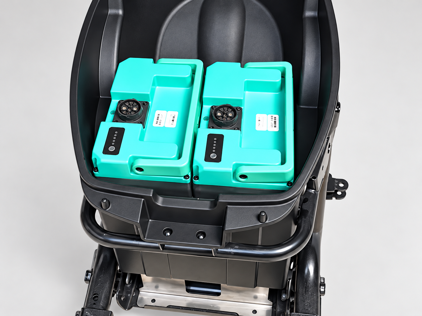 Two battery packs fitted in a vehicle compartment